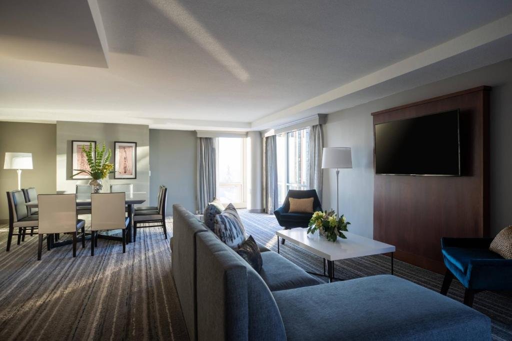 Spacious hotel suite with modern furnishings and large windows