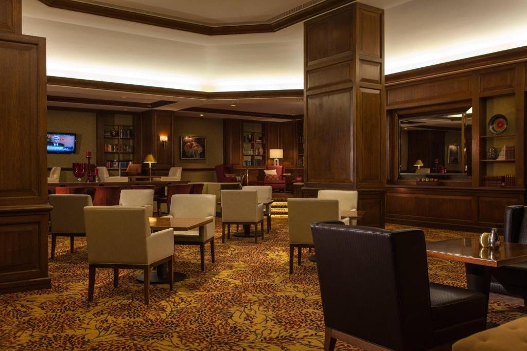Hotel lobby with wooden decor and multiple seating areas